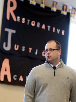 Restorative Justice Academy Associate Director Chirs Blazi leads a class at Goodridge Academy Thursday, Jan. 14, 2016. His classes are an alternative to suspension which draws students from city public schools. Students are allowed to complete school work during their suspensions.