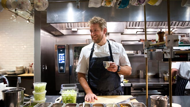 Chef Curtis Stone smiles while working in his kitchen at Maude, a 25-seat restaurant he opened in Beverly Hills.