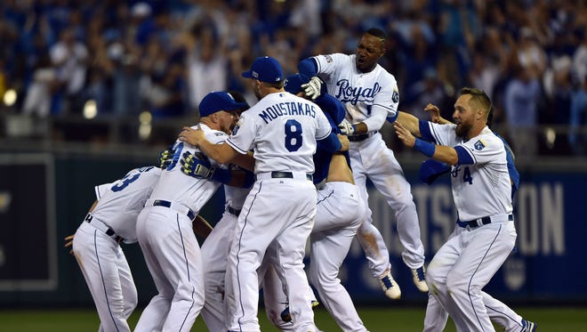 The Royals celebrate after catcher Salvador Perez hits a walk-off single in the 12th inning.