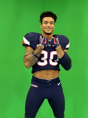 Eli Thomas poses in a UConn uniform during his visit there.