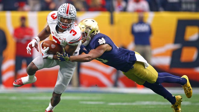 Ohio State Buckeyes wide receiver Michael Thomas (3) is tackled by diving Notre Dame Fighting Irish cornerback Nick Watkins in the second half during the 2016 Fiesta Bowl at University of Phoenix Stadium.