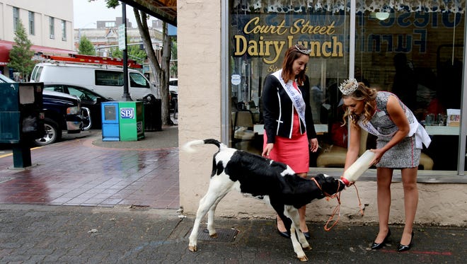 How often do you see young women in tiaras feeding milk to a cow outside of a place called the Court Street Dairy Lunch? It happened Tuesday in Salem. Pictured here, from left, Oregon Dairy Princess First Alternate Gina Atsma, 2016 Oregon Dairy Princess Sara Pierson and Iris, a 10-day-old Holstein calf, represent the "Got Milk" campaign royally.