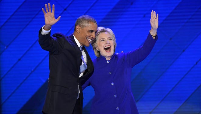 President Barack Obama with Democratic presidential nominee Hillary Clinton after Obama spoke during the 2016 Democratic National Convention in Philadelphia on July 27, 2016.