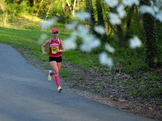 Ladies 2016 Covenant Health Knoxville Marathon winner Gina Rouse, of Knoxville, makes her way down Third Creek Greenway near mile maker 9 during the Covenant Health Knoxville Marathon on Sunday, April 3, 2016. 