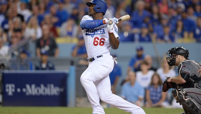 Yasiel Puig hits a single in the fourth inning.