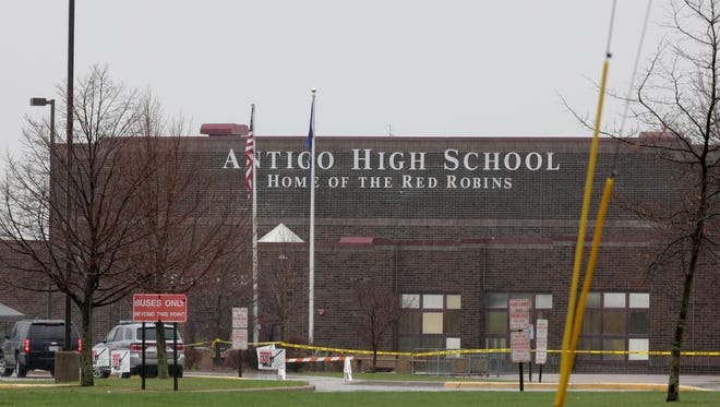 Police tape cordons off an area outside Antigo High School, the site of a shooting that left the perpetrator dead and two others injured, April 24, 2016. 