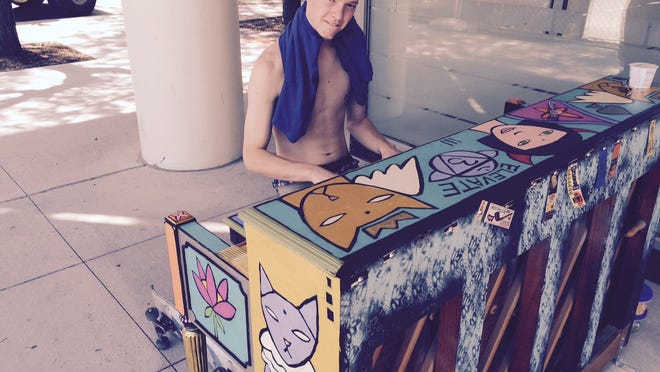Skateboarder Evan Hankins, 17, of Des Moines’ south side played a quick tune Wednesday on the City Sounds piano outside of Capital Square at Fourth and Walnut streets.