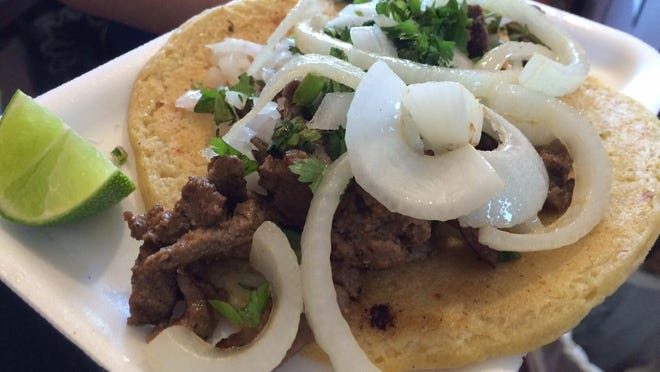 A carne asada taco with cilantro, fried onions and lime from Taquizza in North Fort Myers.