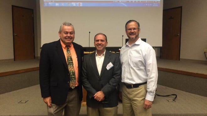 Manpower of the Mid-South franchise owner Jeff Marshall poses with Jeff Francis, left, and Mitchell Cochran, right, Wednesday at the second annual safety and workers’ compensation conference.