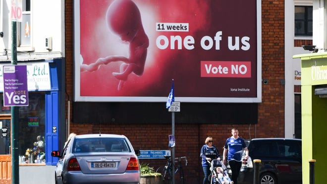 Pedestrians in Dublin on May 13, 2018, pass a billboard urging a 'No' vote in Ireland's referendum on Friday to preserve the Eighth Amendment of the Irish constitution, which outlaws abortion in most cases.