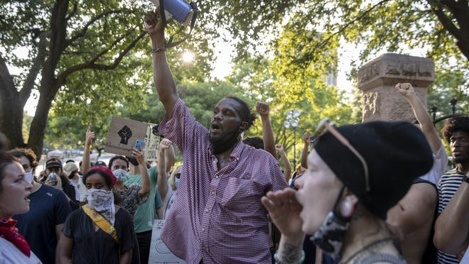 Michael Burnett speaks at a protest at the Capitol on Saturday night to protest the killing of George Floyd in Minnesota and police brutality across the country.