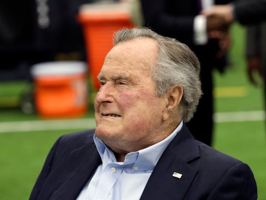 Former president George H.W. Bush arrives for an NFL