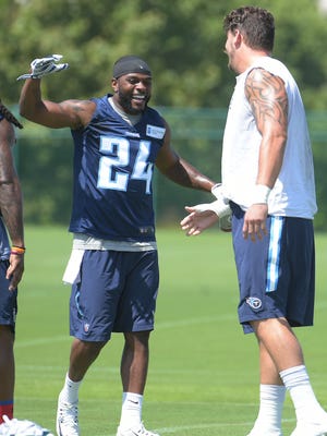 The Titans'  Perrish Cox (24) thanks Taylor Lewan after Lewan was part of a relay that allowed the team to end minicamp early.