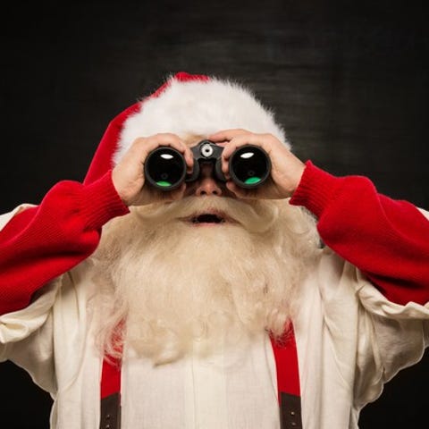 Santa Claus holding a pair of binoculars