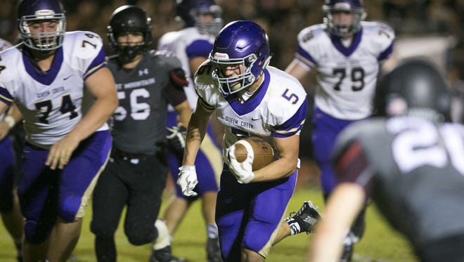 Queen Creek High running back Gavin Danielson scores the game winning touchdown in overtime to defeat Desert Mountain High 20-14 in the high school football game at Desert Mountain High in Scottsdale on Friday, August 21, 2015.