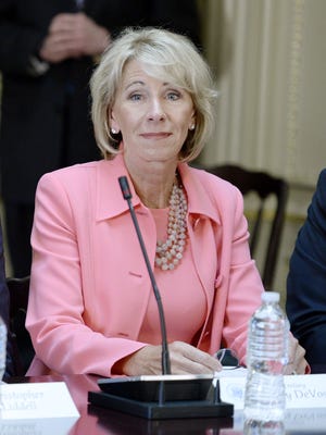 Education Sec. Betsy DeVos listens as US President Donald Trump speaks during a strategic and policy discussion.