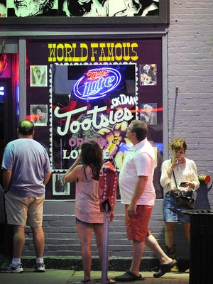 Visitors take a peek inside Tootsies on Broadway in Nashville in 2013.
