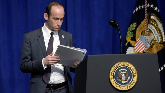 Senior policy adviser Stephen Miller places the remarks for President Trump on the podium before Trump spoke to troops on a visit to U.S. Central Command and U.S. Special Operations Command at MacDill Air Force Base in Tampa, Fla., on Feb. 6, 2017.