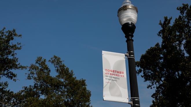 A banner reminds students to socially distance during the first day of fall classes on Tuesday, August 25, 2020 at Ohio State University in Columbus, Ohio. Classes this semester are a mix of virtual and in-person because of the ongoing COVID-19 pandemic. Students wore masks across campus and were reminded to socially distance to prevent the spread of the novel coronavirus.