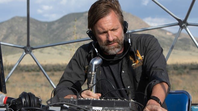 Arthur (Aaron Eckhart) does more than just talk about conspiracy theories.