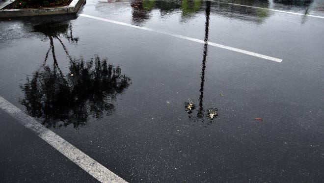 Reflections in a Constitution Boulevard parking lot. Much-needed rain showers hit Salinas Thursday morning.