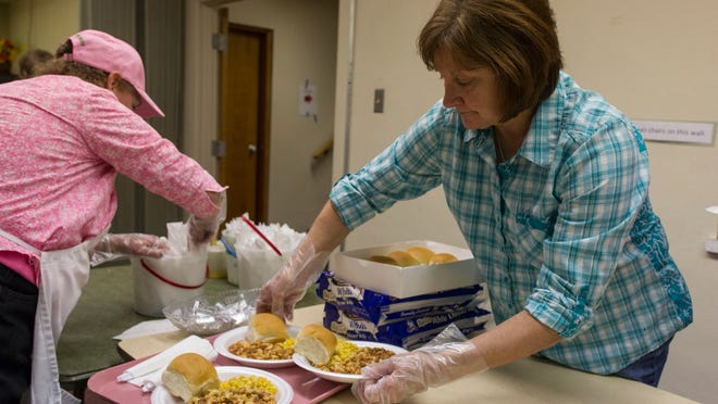 Becky Olmstead prepares a tray of food at Emmett Street Missionary Church.