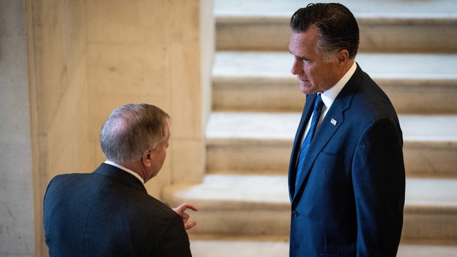 Sen. Lindsey Graham (R-S.C) is shown in March talking with Sen. Mitt Romney (R-Utah) on Capitol Hill. Romney is the focus of intense speculation about whether he will support confirming President Donald Trump's Supreme Court nominee so close to the presidential election.