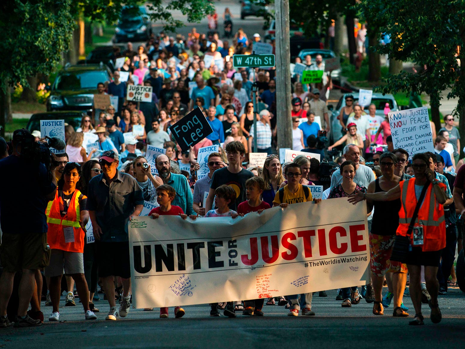 People march down Washburn Avenue on July 20, 2017, in Minneapolis. Several days of demonstrations have occurred after the death of Justine Damond, who was killed late Saturday, July 15, 2017, by a police officer responding to her emergency call abou