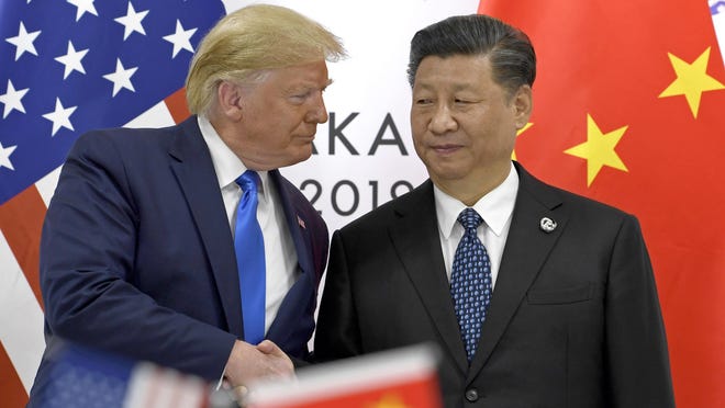 FILE - In this June 29, 2019, file photo, U.S. President Donald Trump, left, shakes hands with Chinese President Xi Jinping during a meeting on the sidelines of the G-20 summit in Osaka, western Japan. The ongoing sharp deterioration in U.S.-China ties poses risks to both countries and the rest of the world. With the U.S. presidential campaign heating up, all bets are that relations with China will only get worse. At stake are global trade, technology and security.