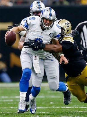 Lions quarterback Matthew Stafford (9) is brought down by Saints defensive tackle Sheldon Rankins (98) in the second half of the Lions' win Sunday in New Orleans.