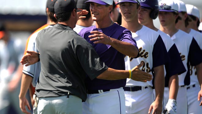 Wylie head coach Clay Martin (center) hugs his brother, Burkburnett head coach Grant Martin, after Wylie's 12-2 win on Saturday, March 18, 2017, at Wylie High School. 