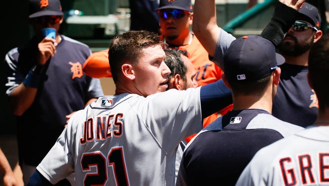 Detroit Tigers center fielder JaCoby Jones (21) is greeted in the dugout after scoring against the Texas Rangers in the third inning at Globe Life Park in Arlington.