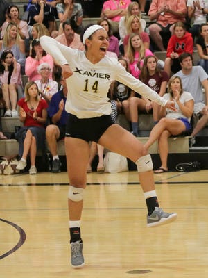 Golden Hinchen celebrates as her Xavier Prep Saints topped Palm Desert 3-1 in a crucial volleyball game Monday.