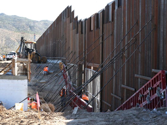 Work continues on an 18-foot high section of the border