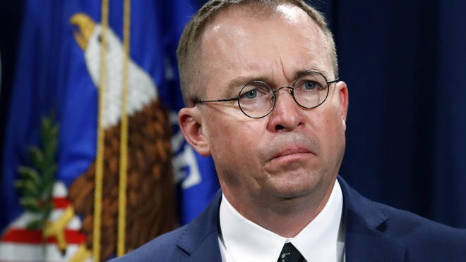 FILE- In this July 11, 2018, file photo Mick Mulvaney, acting director of the Consumer Financial Protection Bureau (CFPB), and Director of the Office of Management, listens during a news conference at the Department of Justice in Washington. White House chief of staff Mulvaney said in an interview with "Fox News Sunday" Democrats will "never" see President Donald Trump's tax returns. Mulvaney says Democrats just want "attention" and are engaging in a "political stunt" after the chairman of the House Ways and Means Committee, Rep. Richard Neal, asked the IRS to provide six years of Trump's personal tax returns and the returns for some of his businesses. (AP Photo/Jacquelyn Martin, File)