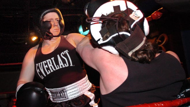 Former Olympic figure skater Tonya Harding has Mark Mason of Newark against the ropes during their bout at the former Gator's in New Castle on Jan. 15, 2005.