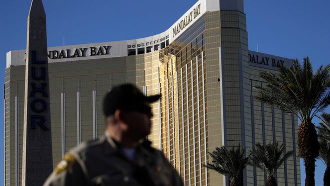 In this Oct. 3, 2017 file photo, a Las Vegas police officer stands by a blocked off area near the Mandalay Bay casino in Las Vegas.