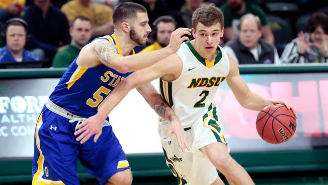 Paul Miller of North Dakota State University takes the ball past Michael Orris of South Dakota State during the Wednesday, Feb. 8, 2017, at the Scheels Center in Fargo.Dave Wallis / The Forum