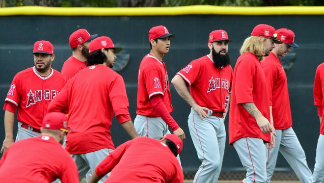 Feb 14, 2018: Los Angeles Angels pitcher Shohei Ohtani (17) and starting pitcher Matt Shoemaker (52) look on during a workout at Tempe Diablo Stadium.