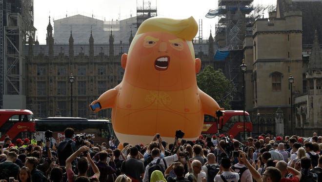 A cartoon baby blimp of President Donald Trump is flown as a protest against his visit, in Parliament Square in London, England.