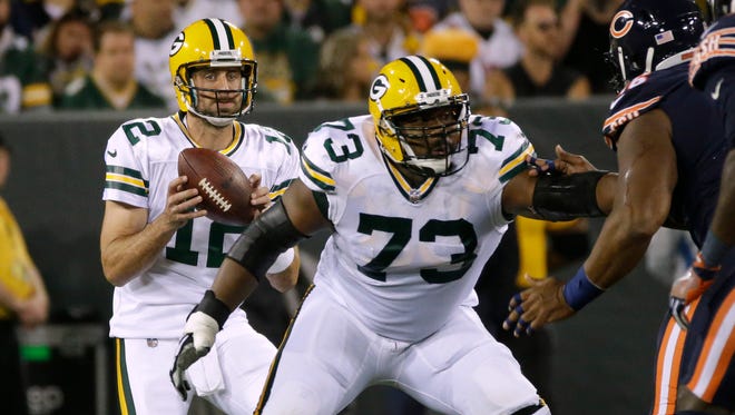 Green Bay Packers offensive guard Jahri Evans (73) provides pass protection for quarterback Aaron Rodgers (12) during the first quarter of their game against the Chicago Bears Thursday, September 28, 2017 at Lambeau Field in Green Bay, Wis.
