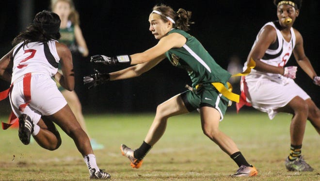 Lincoln's Mallory Eichin goes for a flag pull on Florida High's Trinity Bond.