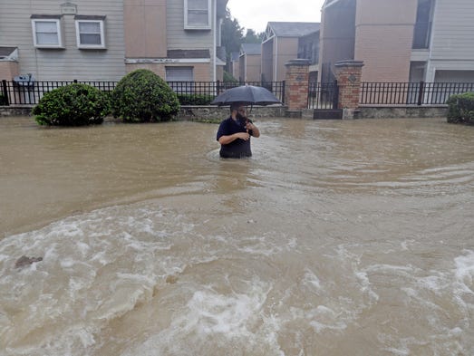 A man wades through floodwaters from Tropical Storm