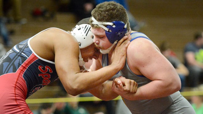 Caleb Wright of Brookfield East tries to escape the grasp of Aric Bohn of Mukwonago in their 220-pound title match.