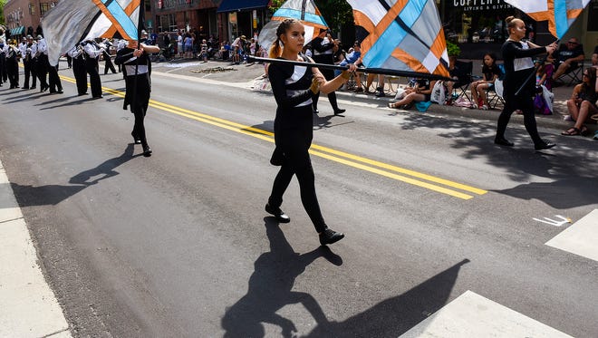 The flags of the St. Cloud Solar Sound Marching Band perform for the crowd June 23, 2018, during the Granite City Days Parade in St. Cloud.
