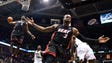 Miami Heat's Dwyane Wade (3) reacts as teammate LeBron