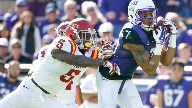 TCU Horned Frogs wide receiver Kolby Listenbee (7) catches a pass over Iowa State Cyclones defensive back Kamari Cotton-Moya (5) during the first half at Amon G. Carter Stadium.