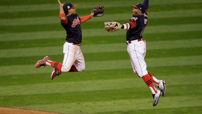 Cleveland Indians' Francisco Lindor and Rajai Davis celebrate after Game 1 of the Major League Baseball World Series against the Chicago Cubs Tuesday, Oct. 25, 2016, in Cleveland. The Indians won 6-0 to take a 1-0 lead in the series.
