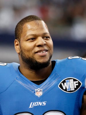 FILE - This is a Jan. 4, 2015, file photo showing Detroit Lions' Ndamukong Suh smiling as he walks across the field during warm ups before an NFL football game against the Dallas Cowboys in Arlington, Texas. Ndamukong Suh can test the open market when free agency begins March 10 after the Lions decided not to use the franchise tag on the star defensive tackle, according to a report on the team's website. (AP Photo/Tony Gutierrez, File)