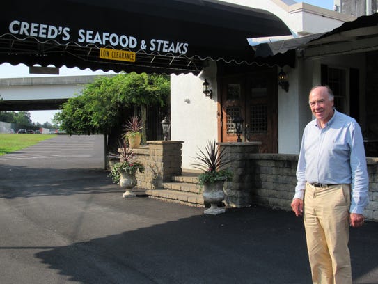 Jim Creed stands in front of his restaurant, Creed's